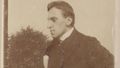 The sepia-coloured picture shows Ossietzky in his younger years. He is wearing a suit and has his hands on his hips. He is looking to the side.